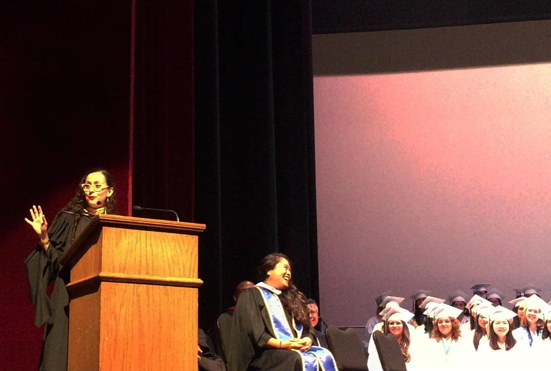 Susana A. Cortés delivering a motivational speech at a graduation ceremony